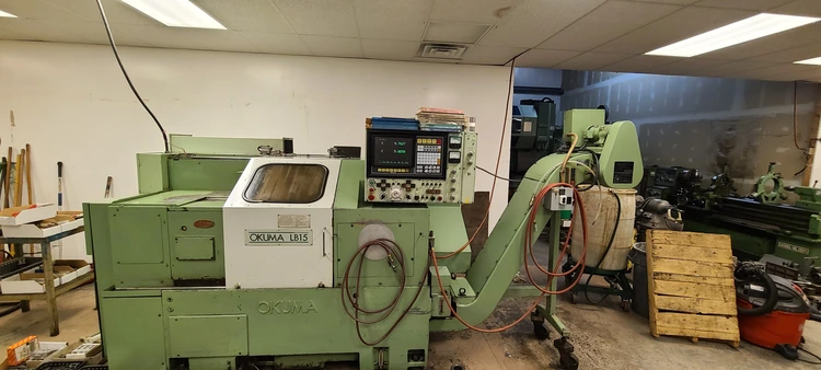Okuma LB15 CNC Turning Center with chip conveyor, New in 1997.